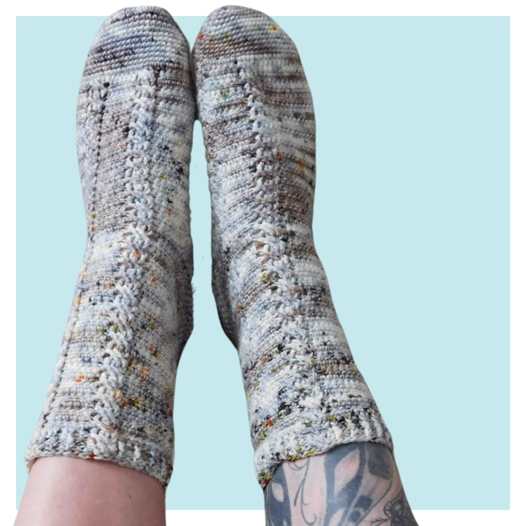 Almost the same crochet socks on turquoise background.