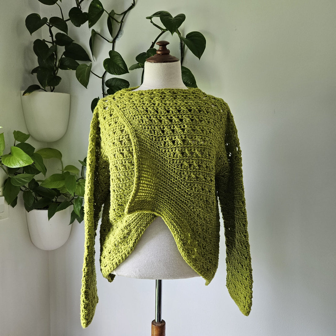 Blueberry Jam Crochet Sweater on turquoise background.