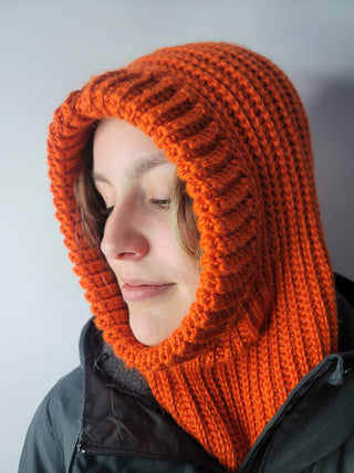 Campfire crochet hood worn by teen on white background.