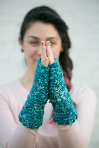 Blue Deep Water Crochet Fingerless Mittens worn by blurry young woman.