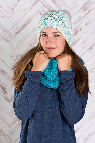 Eliane Crochet Hat and Infinity Scarf worn by young woman in front of white background.
