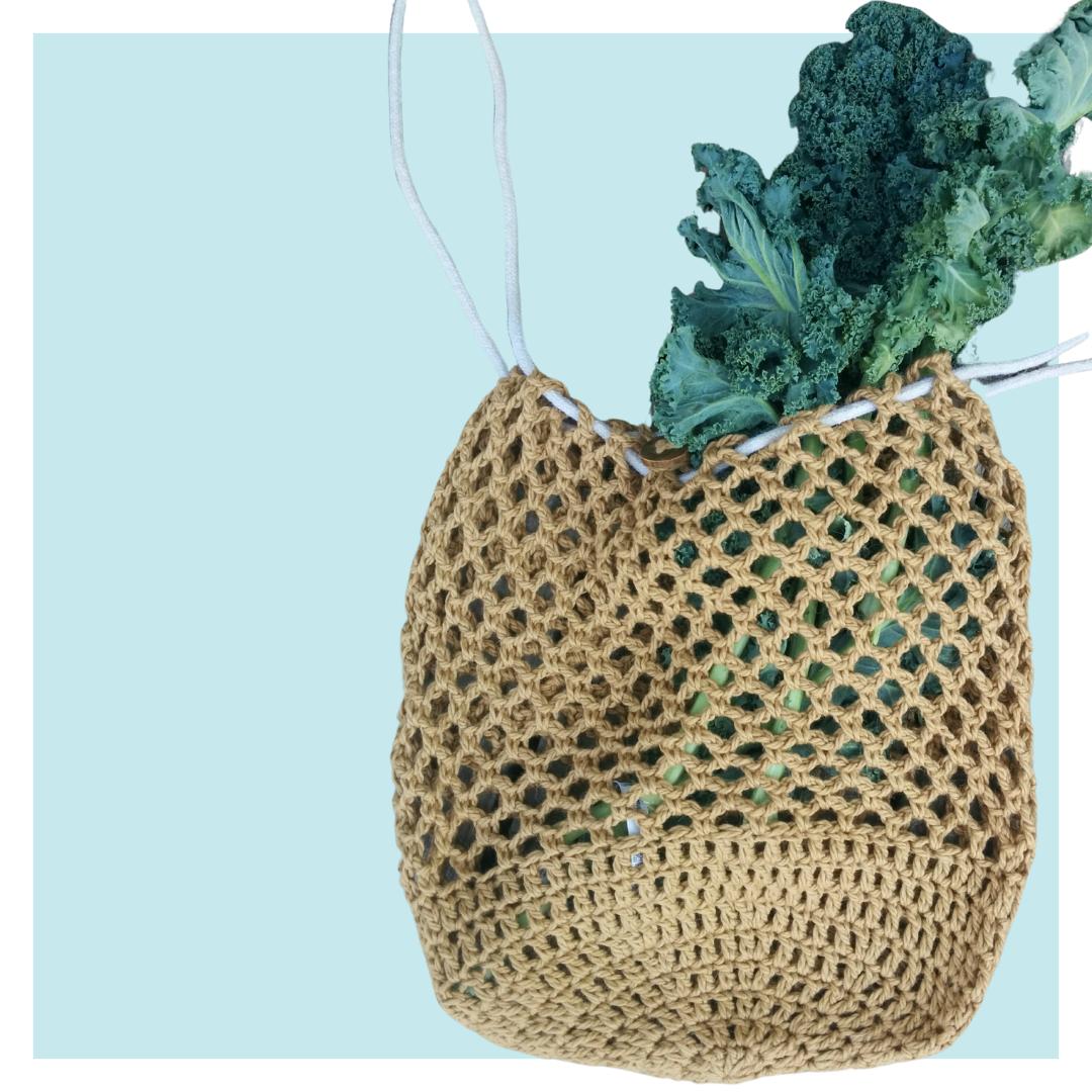 Estelle crochet market bag on turquoise background.