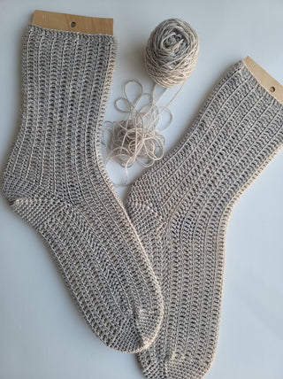 Flanken crochet socks on white background.