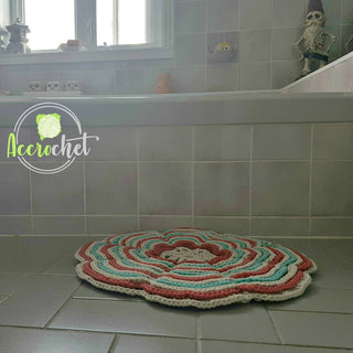 Flower-Power Crochet Bath Mat in front of a bathtub.