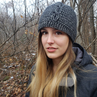 Forester Crochet Hat worn by woman with long hair in a forest.