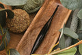 Furls_Metal_Onyx_Crochet_Hook in wooden tray with leaves and blanket flatlay.