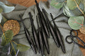 Furls Metal Onyx Crochet Hooks on blanket with leaves flatlay.