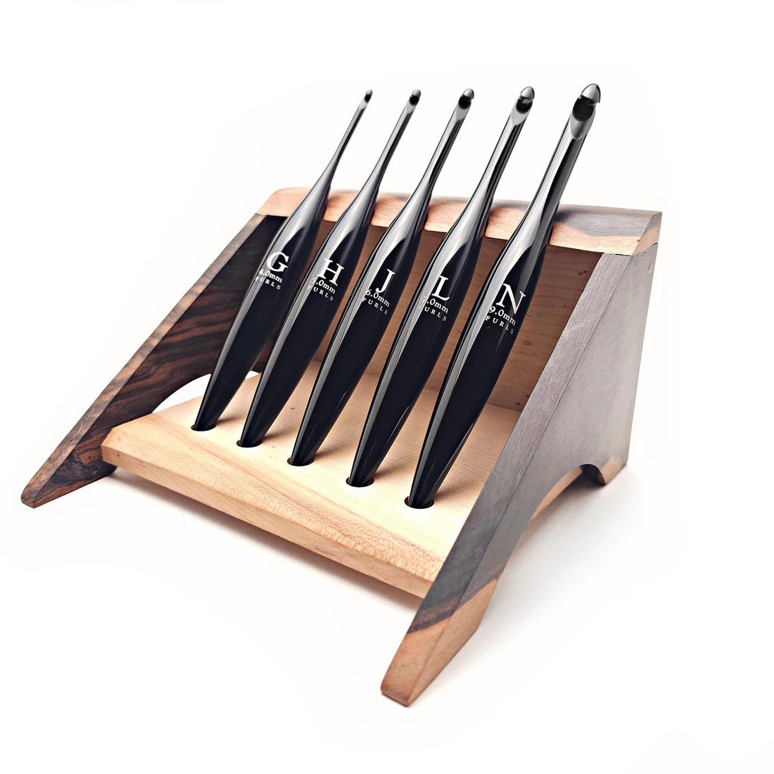 Furls_Metal_Onyx_Crochet_Hook in wooden tray with leaves and blanket flatlay.