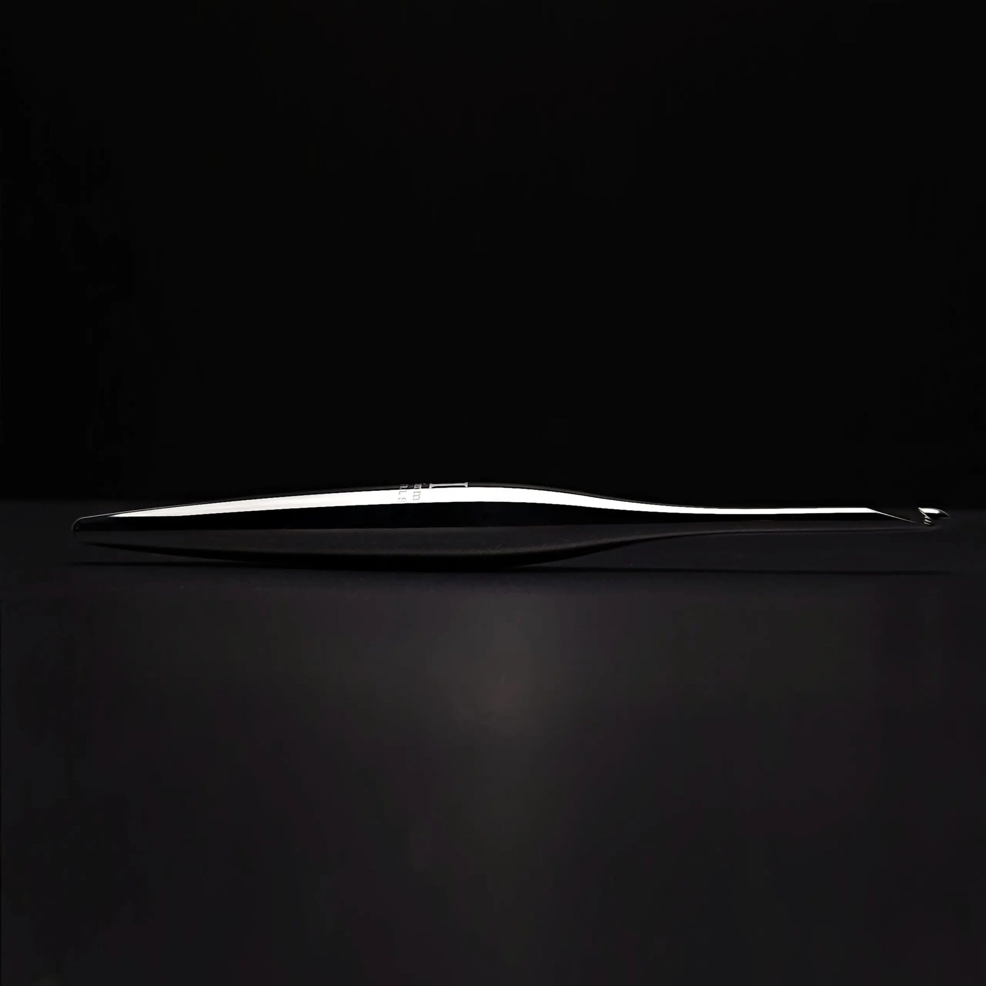 Furls Streamline Metal Silver Hooks on black background.