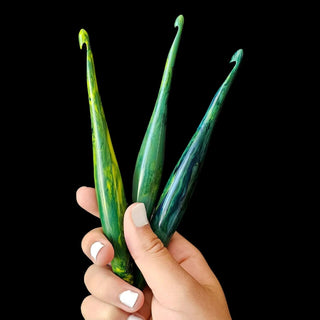 Furls Streamline Virgo Hooks held against black background.