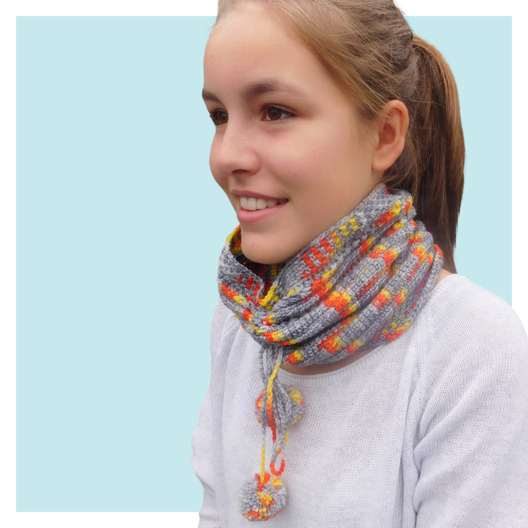 Girl on fire crochet cowl worn by teen on turquoise background.