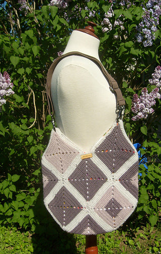 Granny Square Beach Bag on mannequin in front of lilac tree.