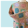 Granny lives here crochet sweater on turquoise background