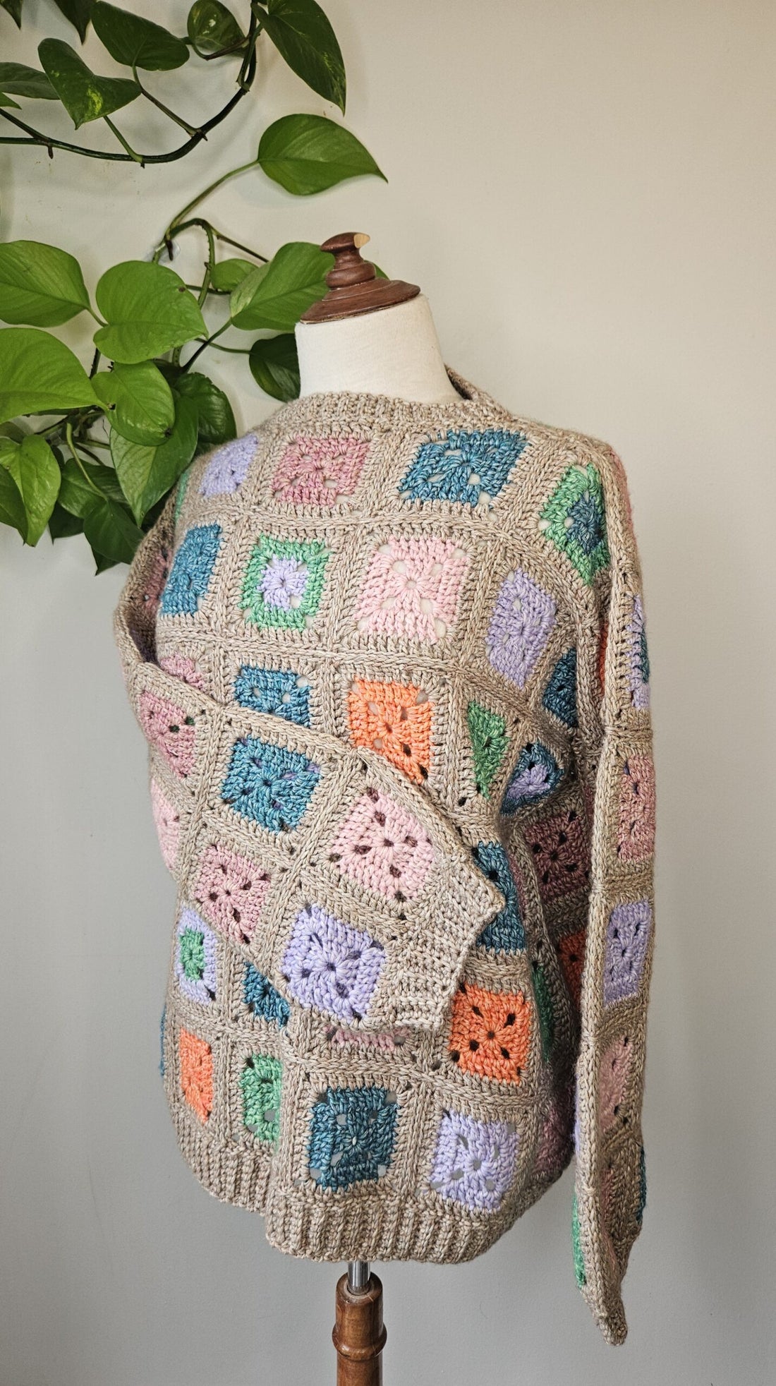 Granny lives here crochet sweater on turquoise background
