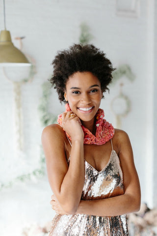 Pink Hélène Crochet Cowl worn by Black woman wearing silver top.
