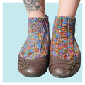 Josephine Crochet Socks on turquoise background.