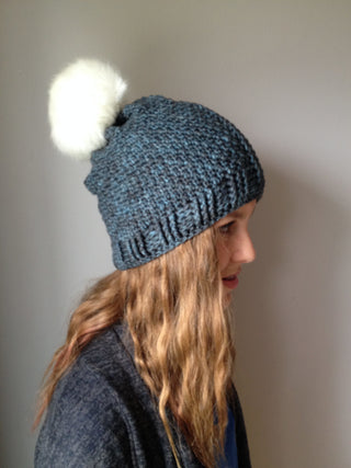 Blue Lea Cabled Crochet Hat worn by teen facing the right.