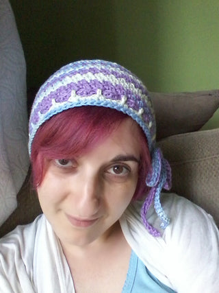 Lemonade Crochet Hat worn by woman against green background.