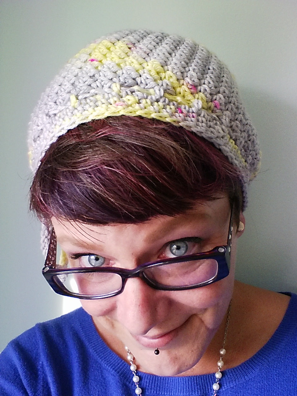 Lemonade Crochet Hat worn by woman wearing glasses and a blue sweater.