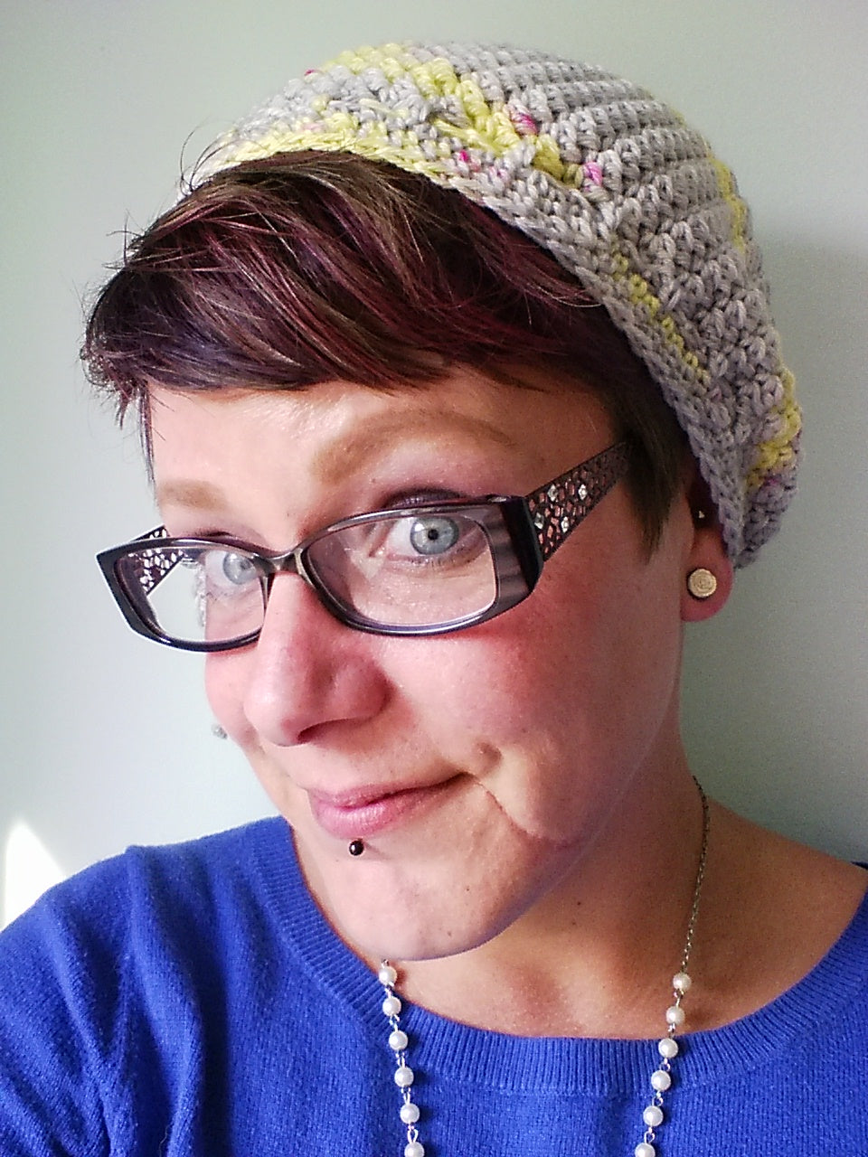 Lemonade Crochet Hat worn by woman wearing glasses and a blue sweater.