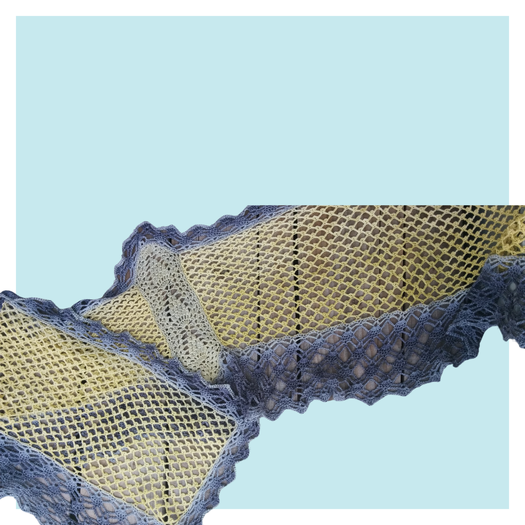 Libellule crochet stole on turquoise background.