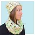 Lucky Charms Crochet Hat and Cowl worn by teen on turquoise background.