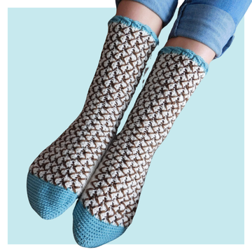 Mint Chocolate Chip crochet socks on turquoise background.