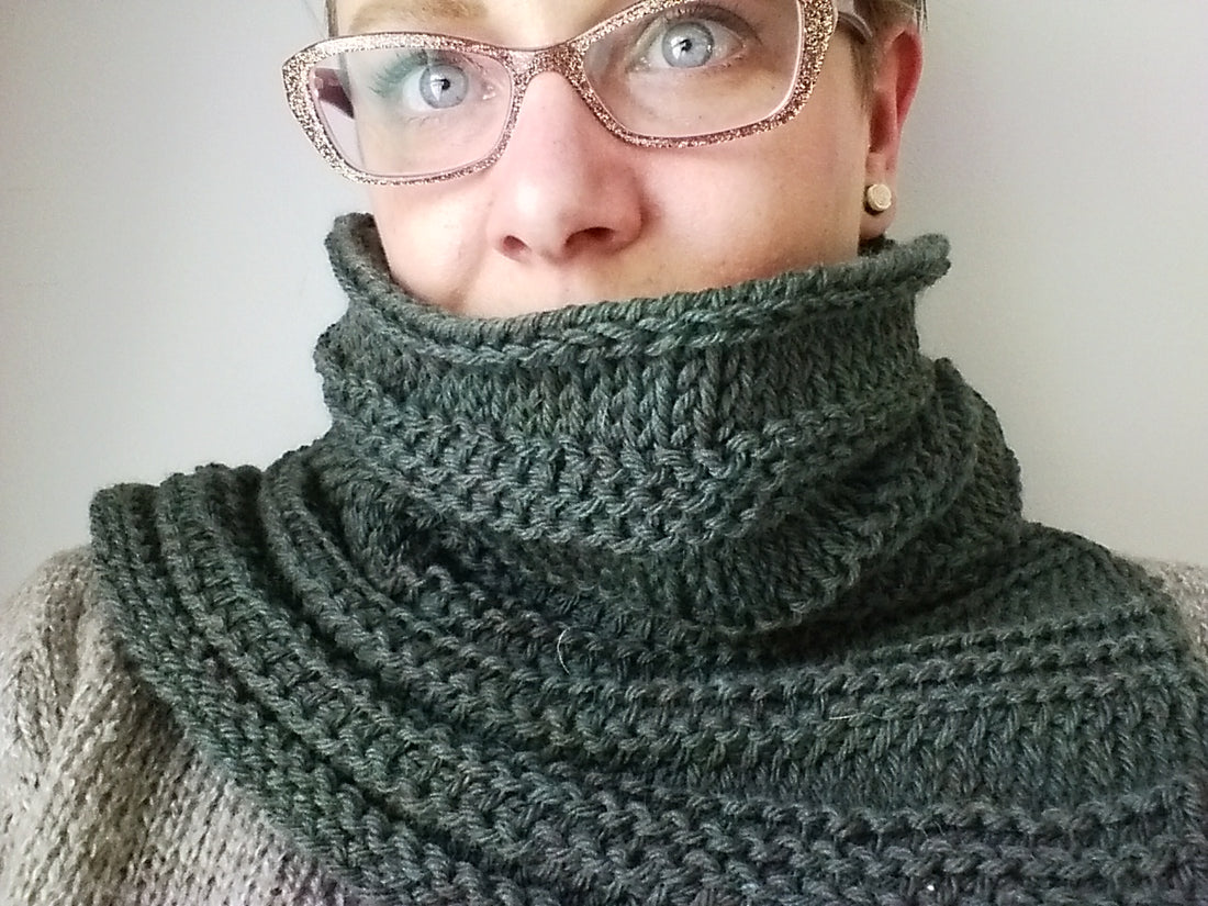 Obstinate Tunisian crochet cowl worn by woman wearing glitter glasses.
