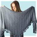 Orchard Tunisian crochet shawl on turquoise background.