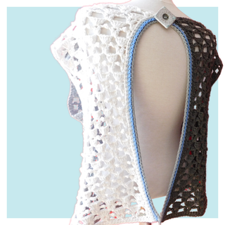 Peek-a-blue crochet top on turquoise background.