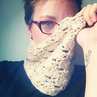 Petunia Crochet Cowl worn by woman wearing glasses.