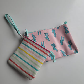 Pink pleather with cacturs print and striped pouches.