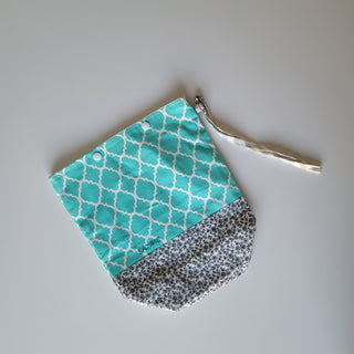 Project bag with turquoise and white, and gray and white patterned fabric.