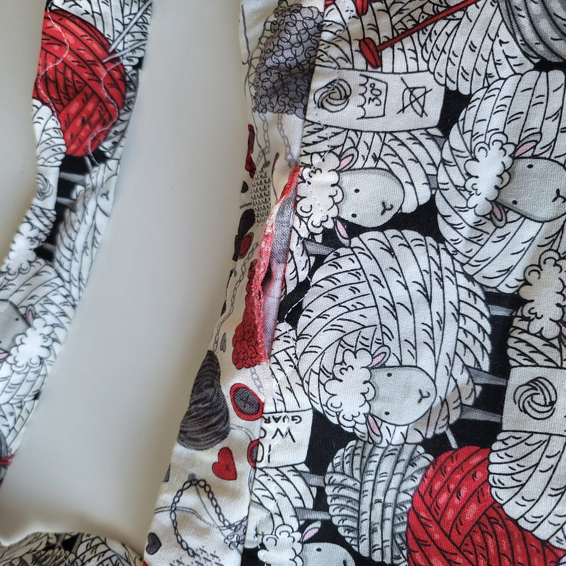 Project bag red, white and black fabric with sheep.