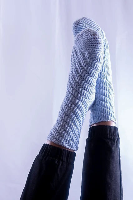 Skyscraper crochet socks on white background.