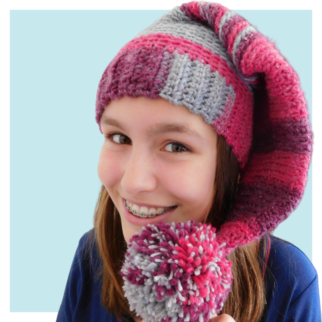 Sleeping Nancy crochet elf hat worn by teen on turquoise background.