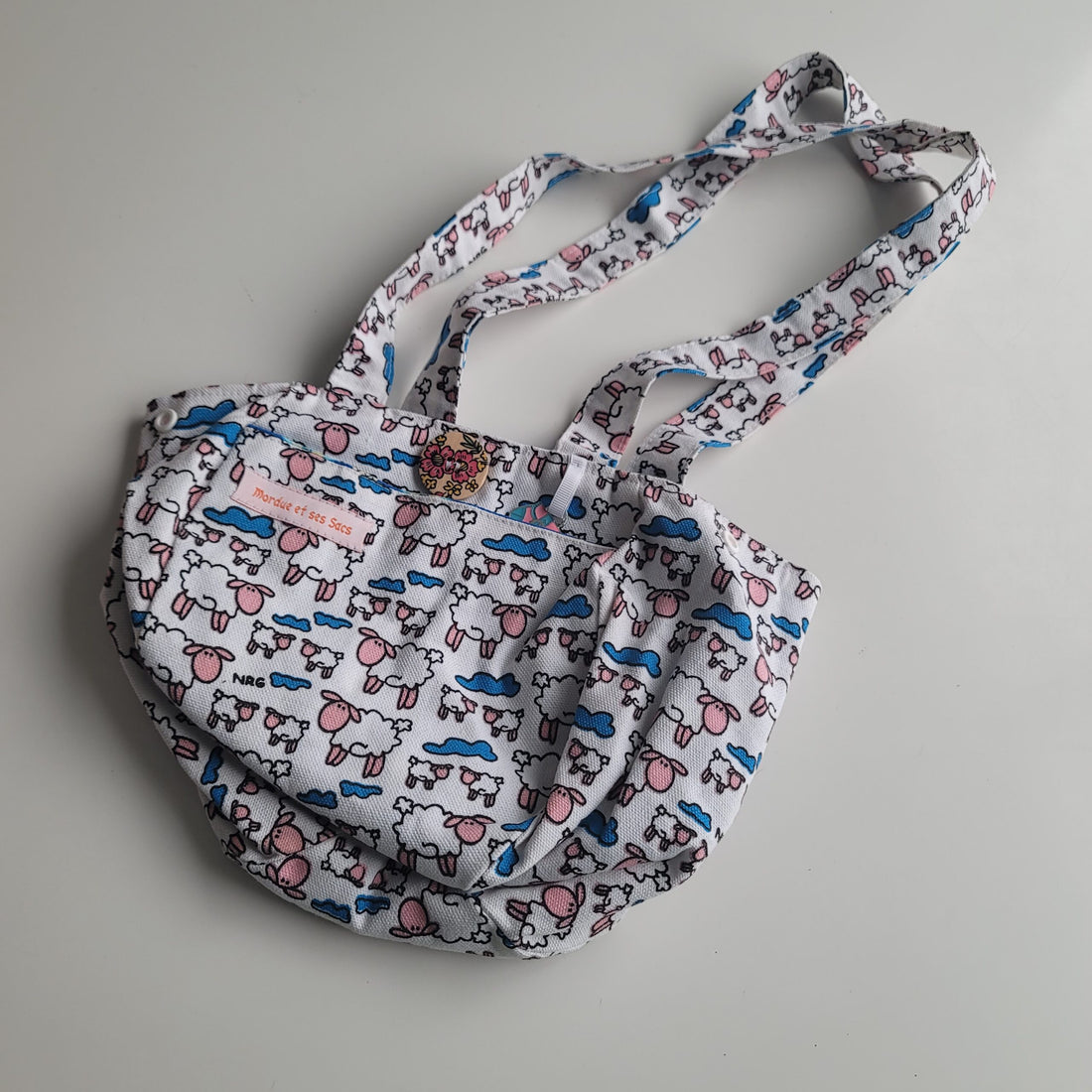 Small project bag with cartoon sheep and blue cloud print.