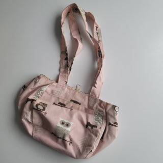 Small project bag with cartoon owls on pink fabric.
