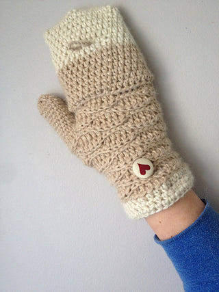Sweetheart crochet mitten worn on white background.