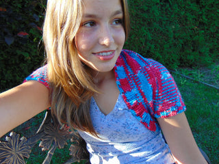 The rocket crochet shrug worn by teen outside in summer.