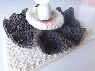 Trio of crochet washcloths on white background.