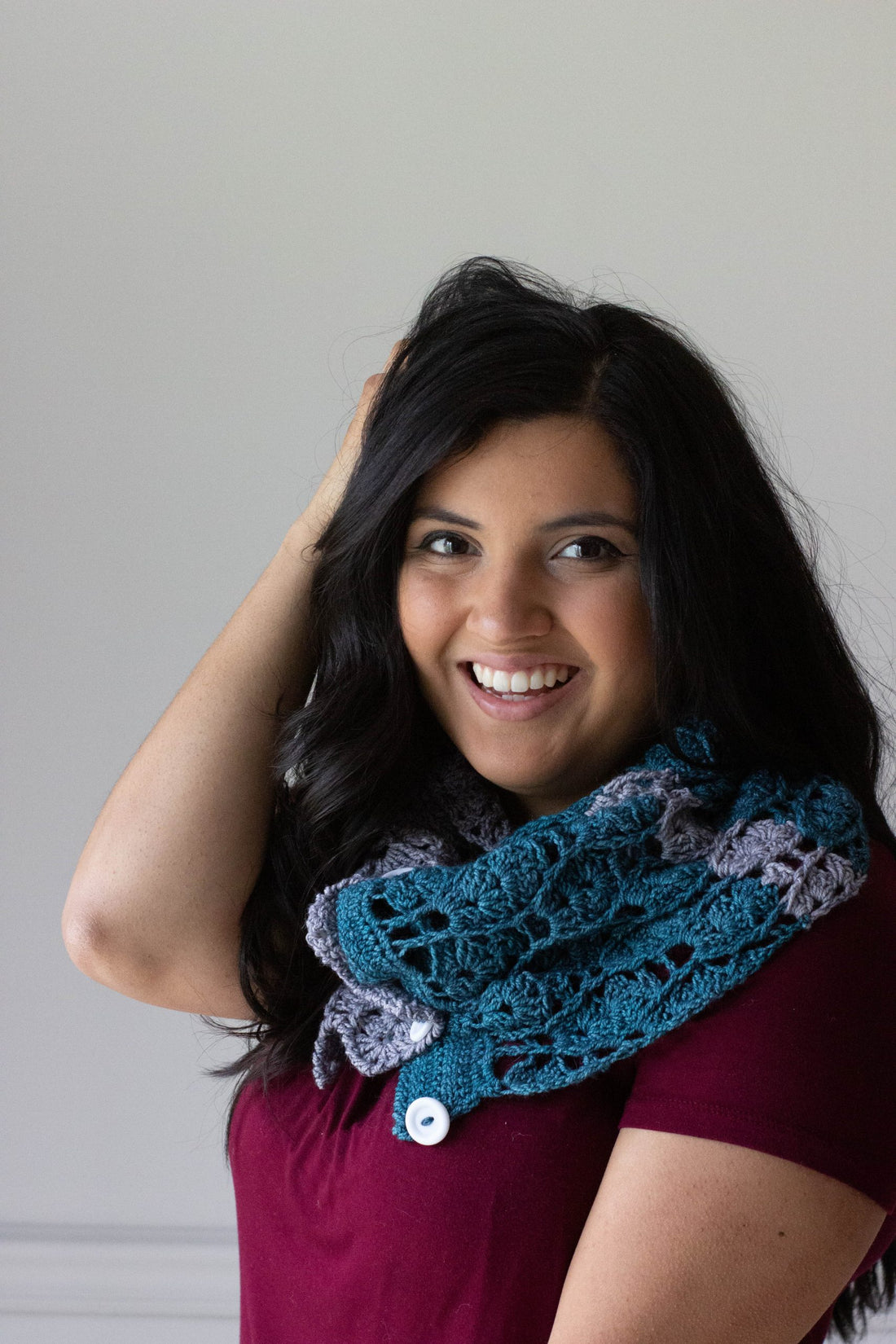 Wavelength crochet cowl worn by woman wearing red t-shirt.