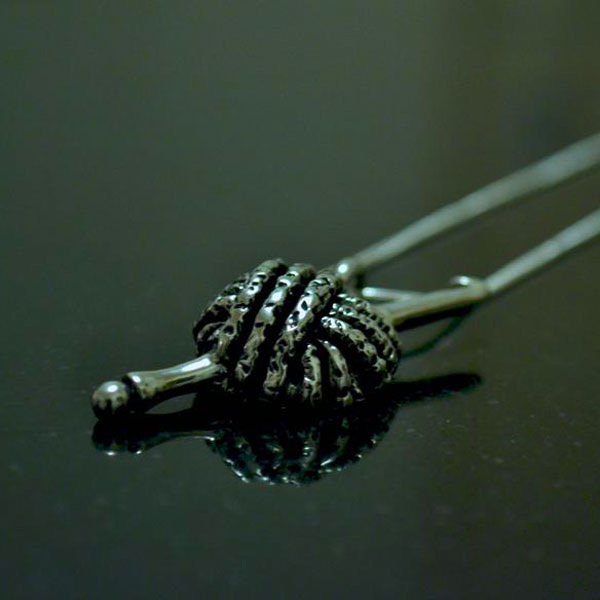 Yarn and hook pewter pendant.