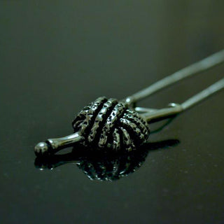 Yarn and hook pewter pendant.