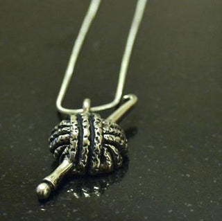 Yarn and hook pewter pendant.