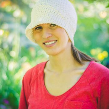 Woman wearing crochet bella sun hat image (c) Emily Truman photography.