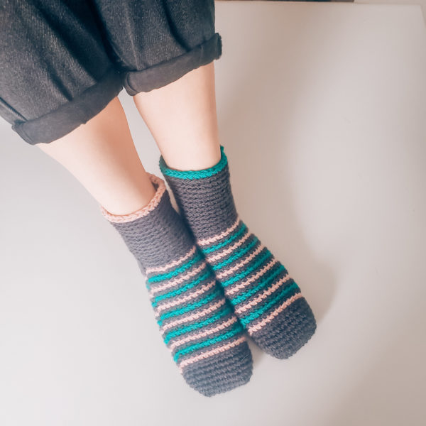 Striped crochet slippers worn