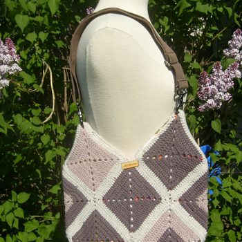 Granny Square crochet Bag on mannequin in front of lilac tree