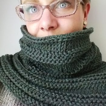 Woman wearing green Tunisian crochet cowl