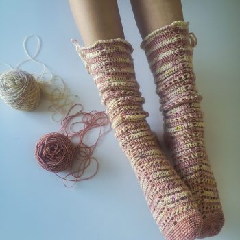 Pink and cream long crochet socks, worn